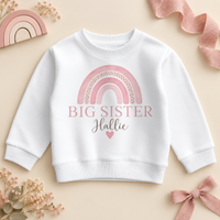 Personalised Big Sister sweatshirt with a soft pink watercolour rainbow, the name in script and a small heart
