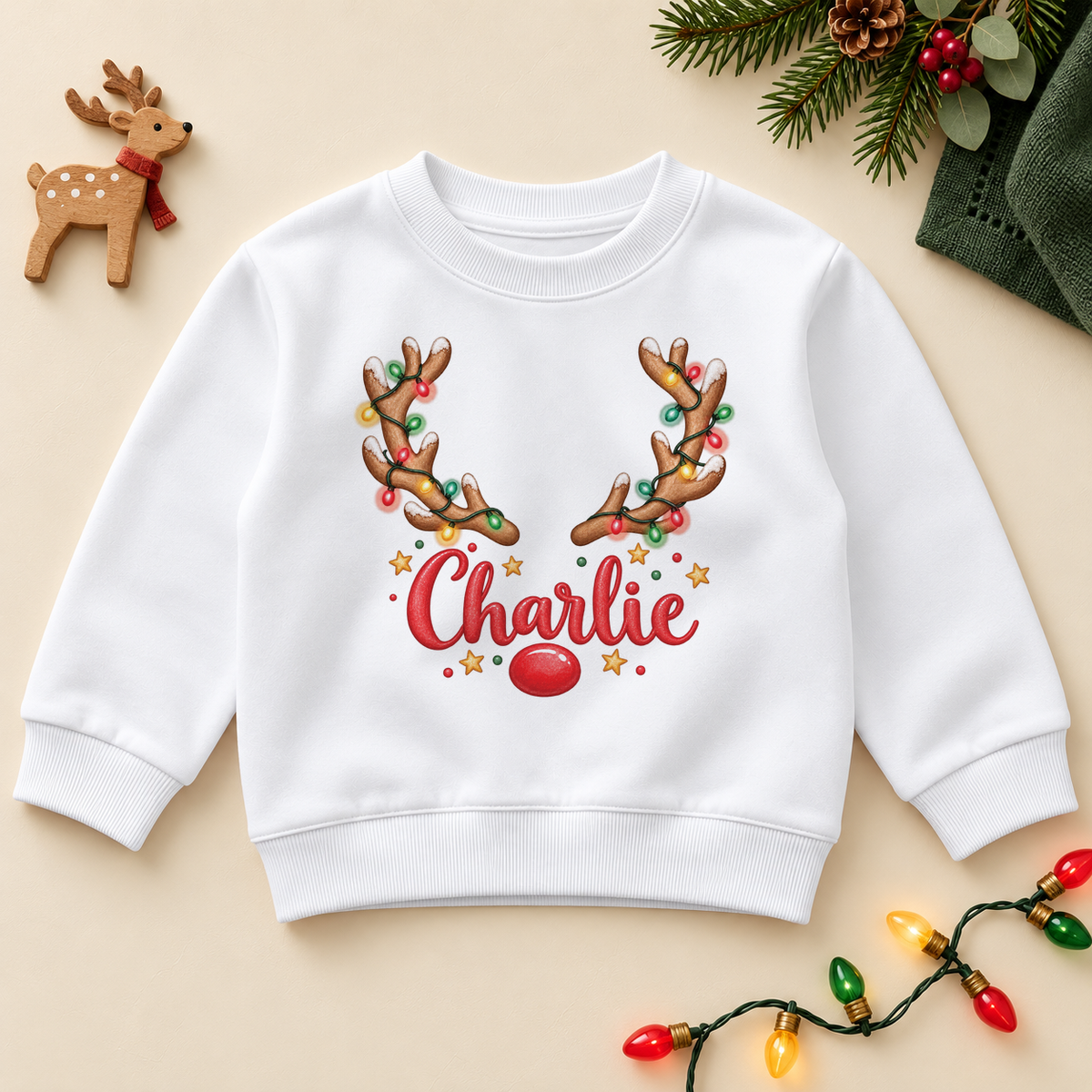 Personalised Name Kids Jumper Reindeer Lights Garland Festive Antlers Red Nose Christmas Gift. Example name shown.