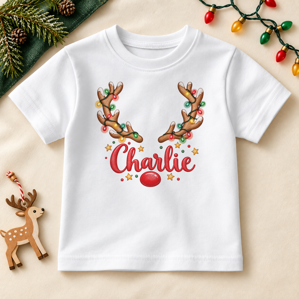 Personalised Name Kids T-Shirt Reindeer Lights Garland Festive Antlers Red Nose Christmas Gift. Example name shown.