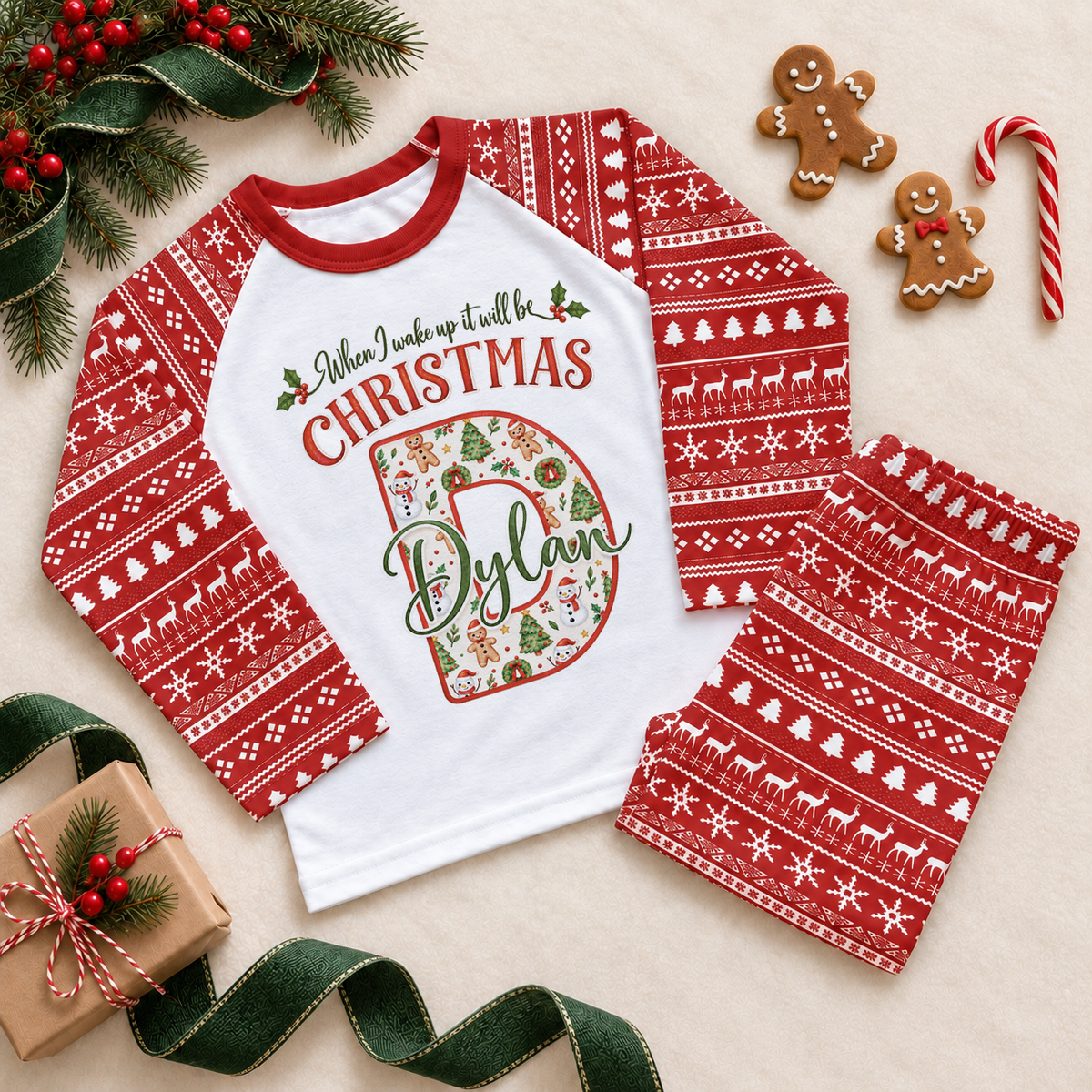 Red and white pyjama set. The print features a cream initial filled with little festive motifs and outlined in red.