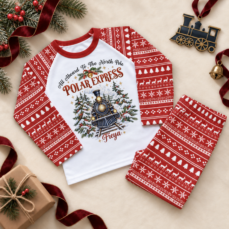 Red and white pyjama set. The print features a blue steam train with snowy fir trees, holly and a bell.