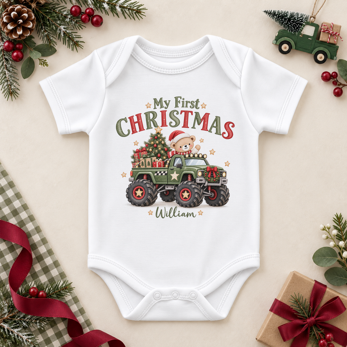 White baby bodysuit with a green monster truck carrying a teddy, tree and gifts, plus My First Christmas lettering and the example name William.