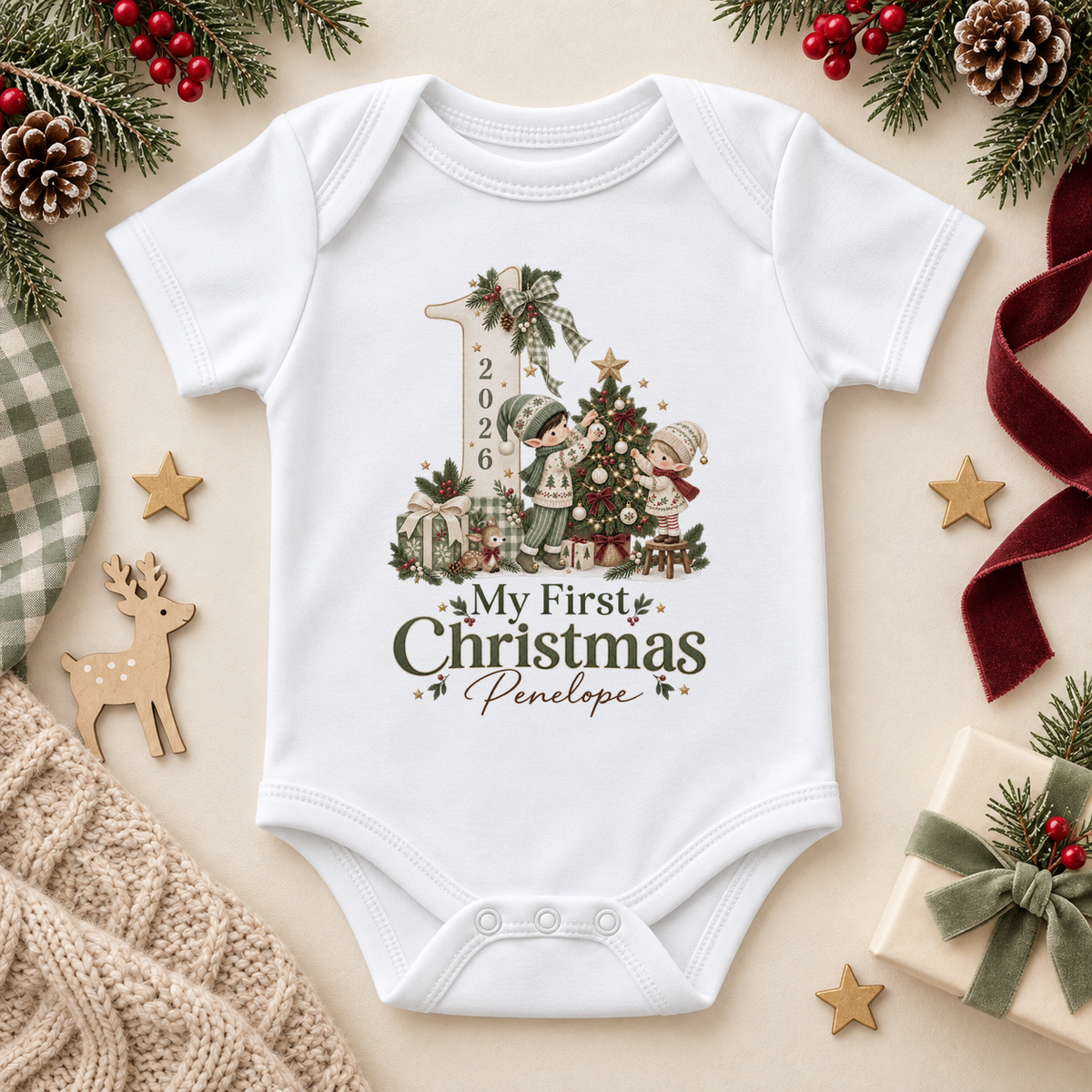 White baby bodysuit. The print features a large number one with a printed year, little elves, a decorated tree and presents.