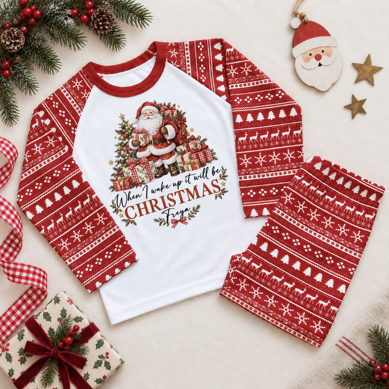 Red and white pyjama set. The print features Santa beside a decorated tree and wrapped presents.