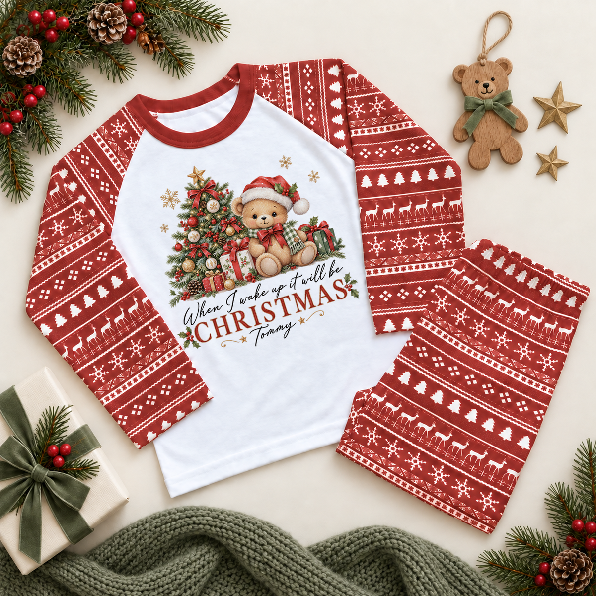 Red and white pyjama set. The print features a teddy beside a decorated Christmas tree and wrapped presents.