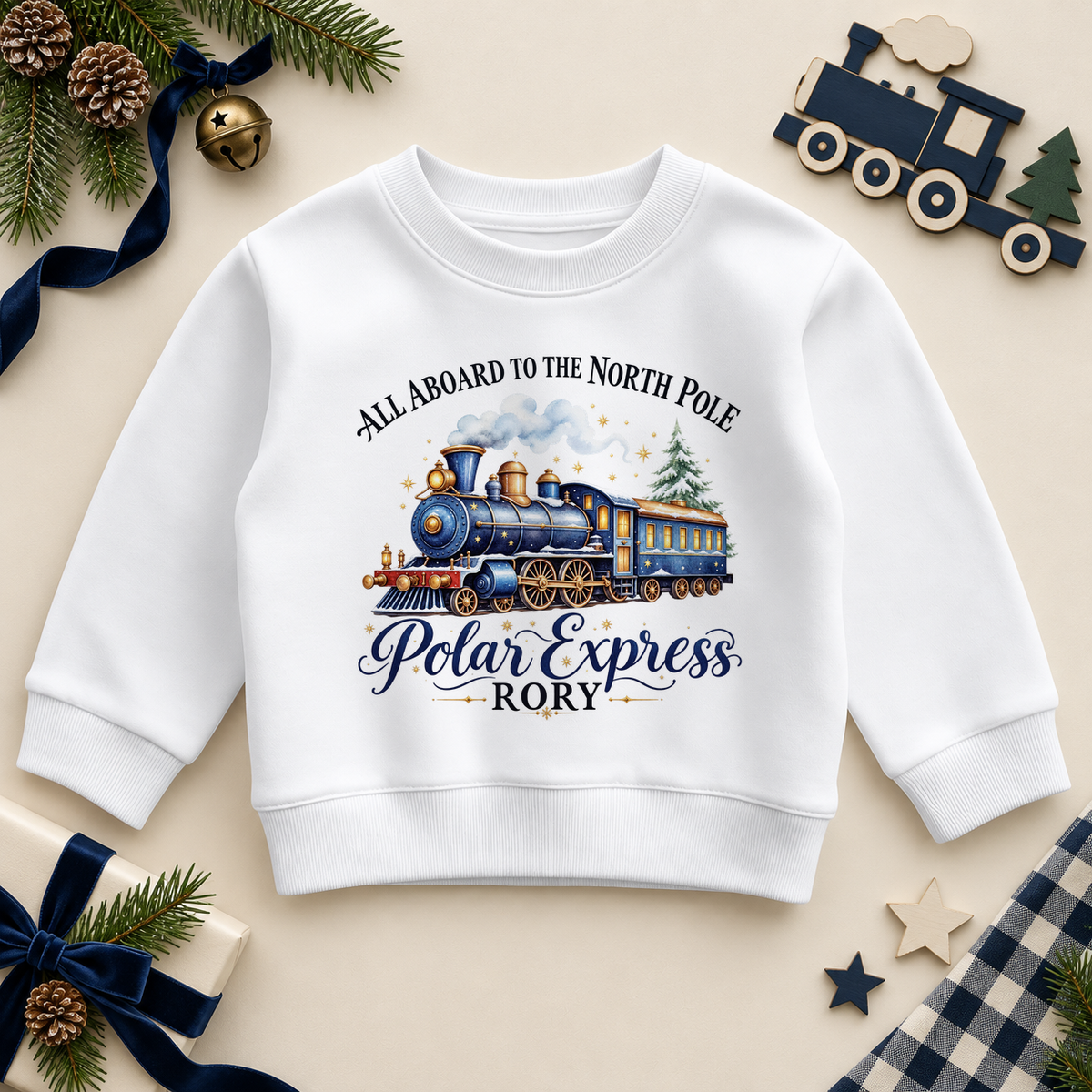 White children’s sweatshirt. The print features a blue and brass steam train with a snowy tree and North Pole lettering.