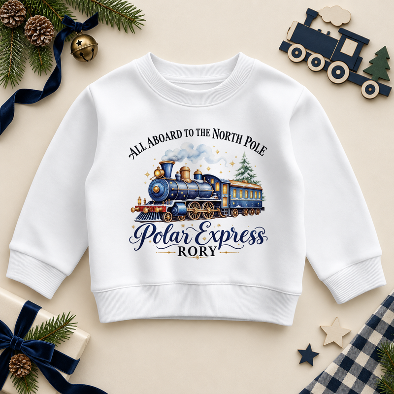 White children’s sweatshirt. The print features a blue and brass steam train with a snowy tree and North Pole lettering.