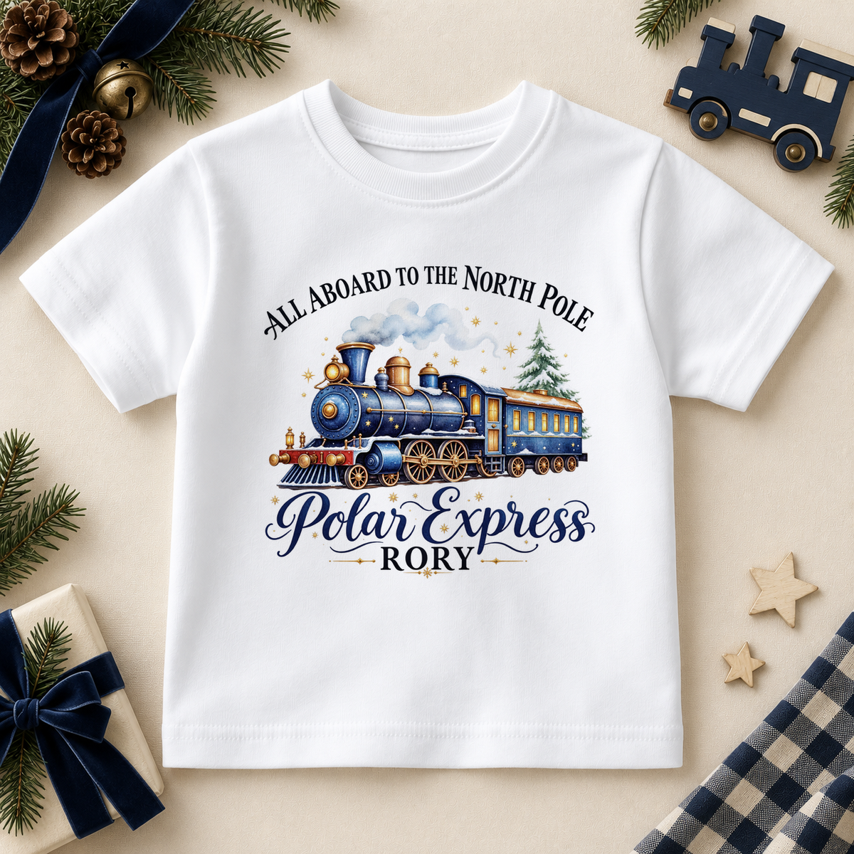 White children’s T-shirt. The print features a blue and brass steam train with a snowy tree and North Pole lettering.
