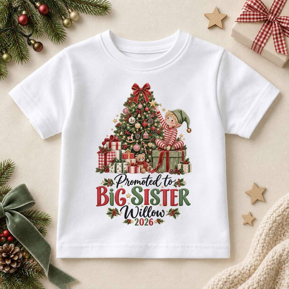 White children’s T-shirt. The print features an elf decorating a Christmas tree above a Big Sister announcement.