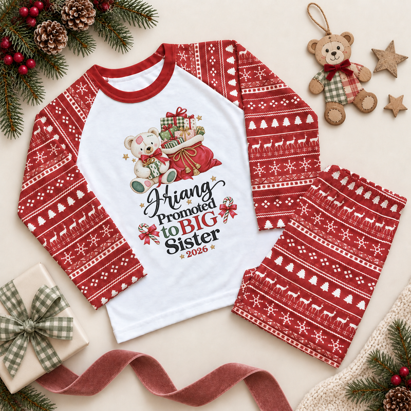 Red and white pyjama set. The print features a teddy holding a gift beside a red sack of presents and Big Sister lettering.