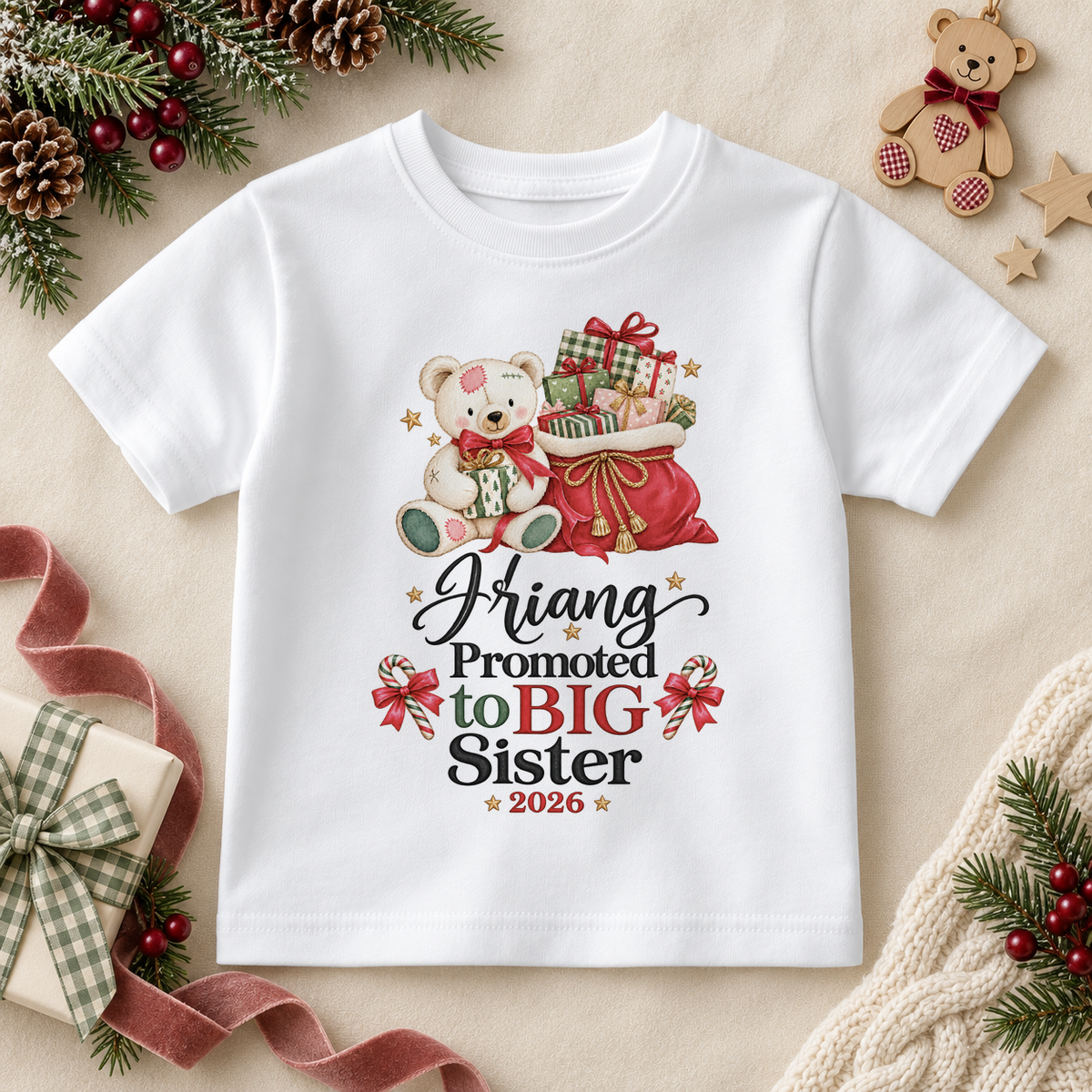 White children’s T-shirt. The print features a teddy holding a gift beside a red sack of presents and Big Sister lettering.