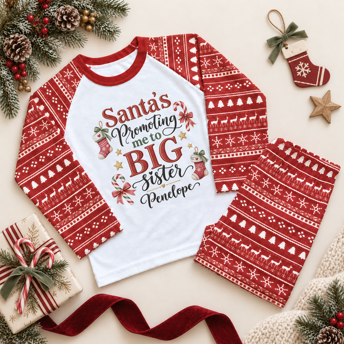 Red and white pyjama set. The print features Big Sister announcement lettering with knitted stockings, candy canes and little stars.