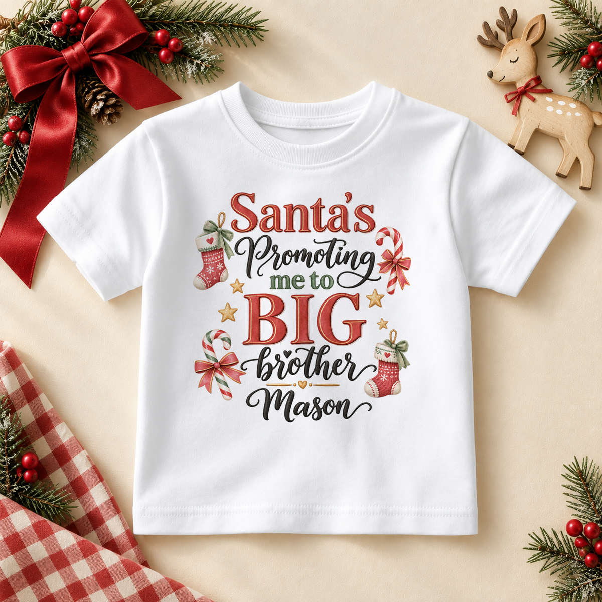 White children’s T-shirt. The print features Big Brother announcement lettering with knitted stockings, candy canes and little stars.