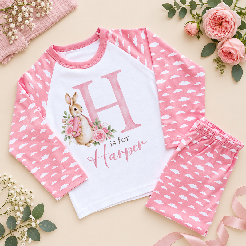 Personalised pink cloud pyjamas with a large pink H initial, a watercolour bunny in a pink jacket with pink roses and H is for Harper as an example name