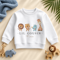 Lil Cousin safari animals sweatshirt personalised with Finn, with blue textile and matching safari toys.