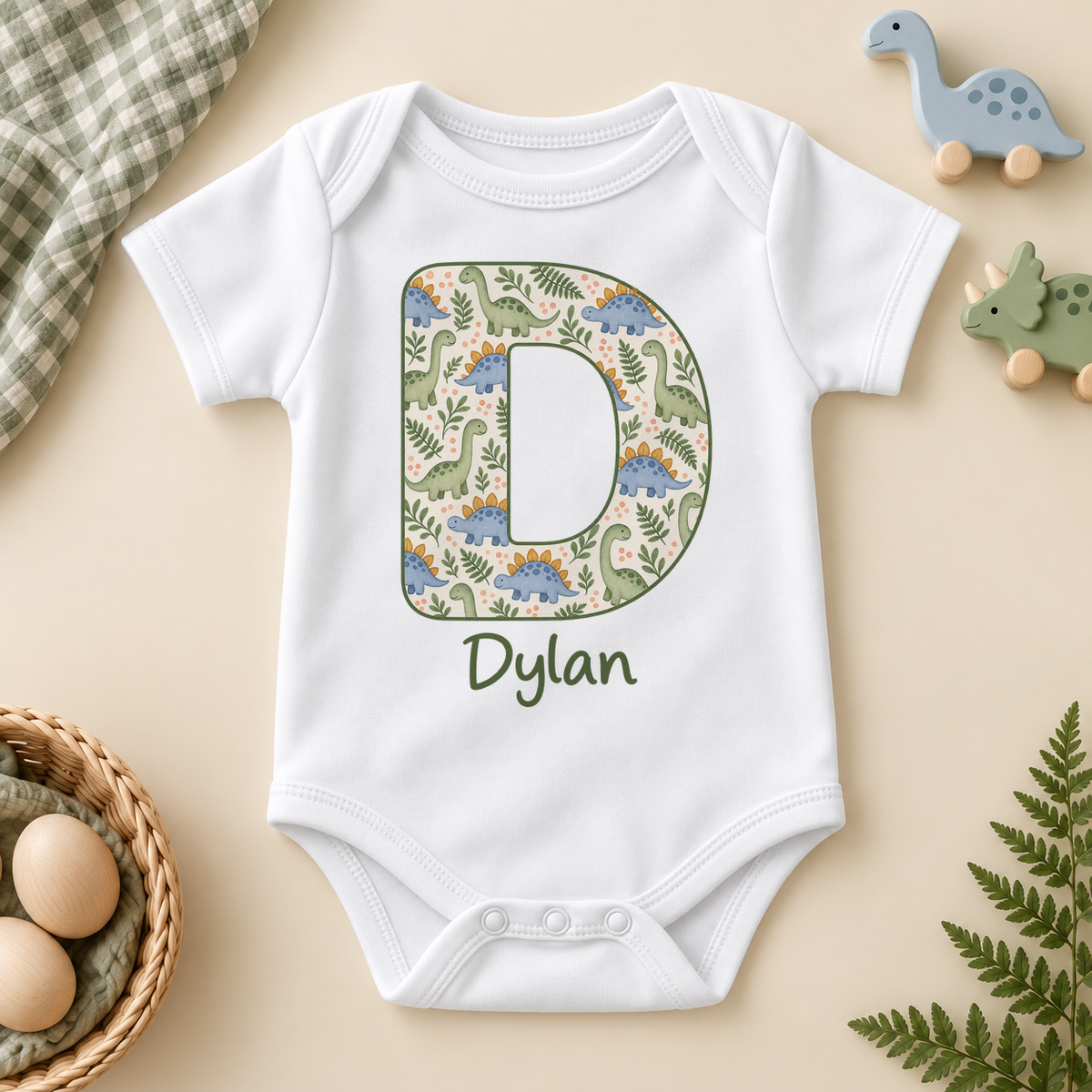 Personalised Dinosaur Initial Baby Vest Bodysuit; example name shown.