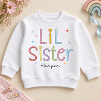 Personalised Lil Sister white sweatshirt with pastel outlined letters, hearts and Harper example name.