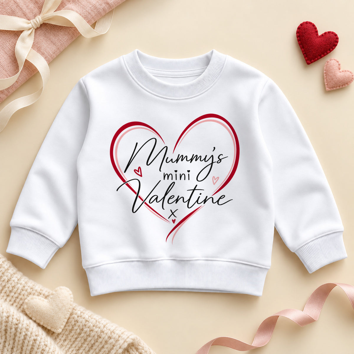 Mummy's mini valentine toddler sweatshirt: a white jumper with black script inside a red and pink outlined heart with tiny hearts