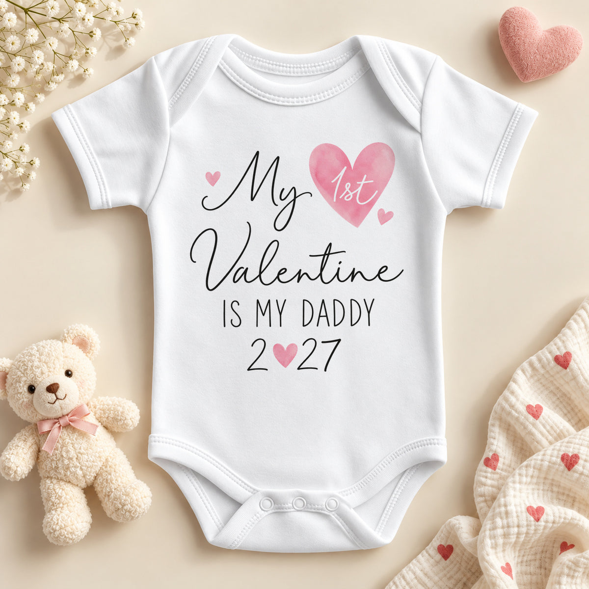 My 1st Valentine is my Daddy baby bodysuit: a white baby vest with black script, 1st in a watercolour pink heart and the year with a little heart for the zero