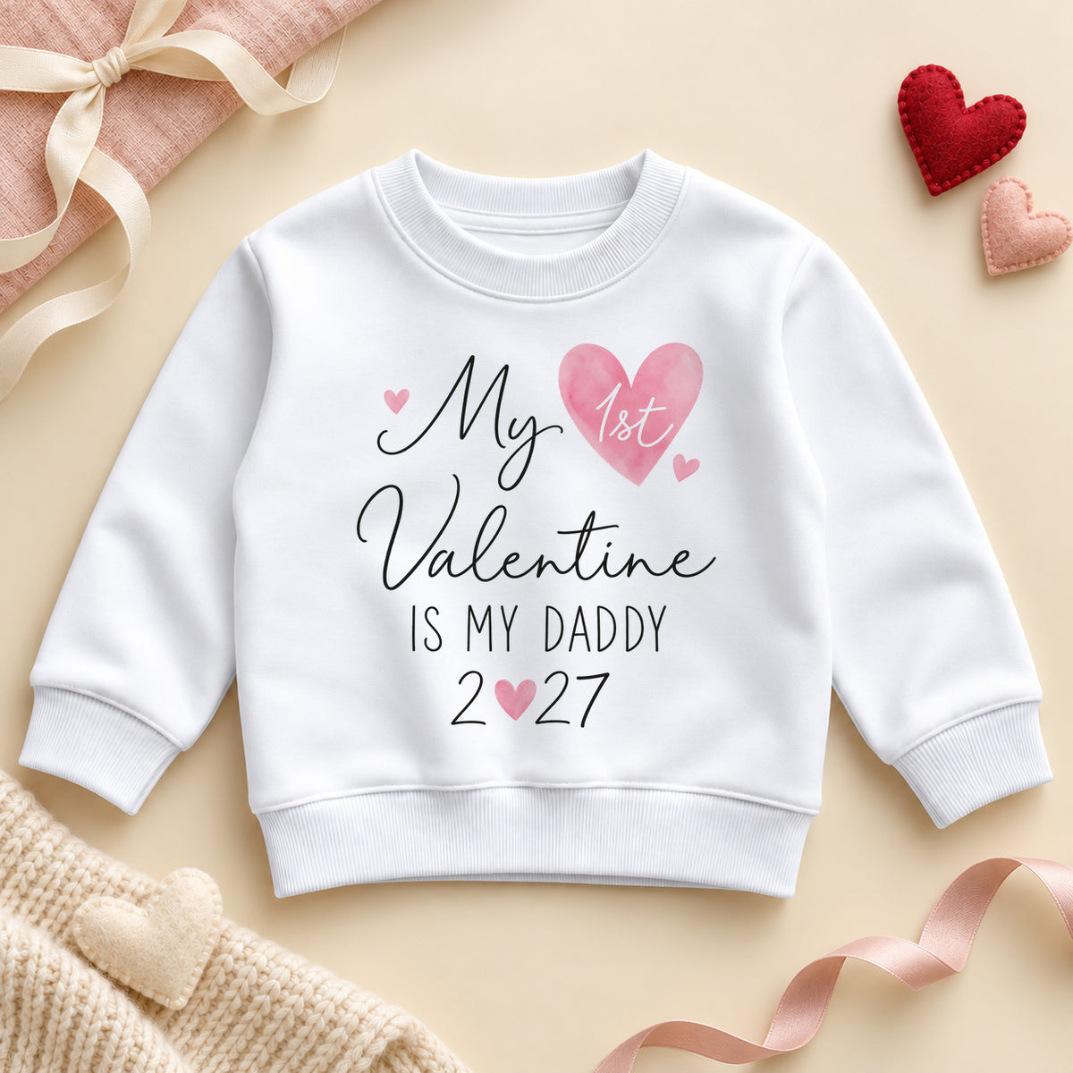My 1st Valentine is my Daddy toddler sweatshirt: a white jumper with black script, 1st in a watercolour pink heart and the year with a heart for the zero