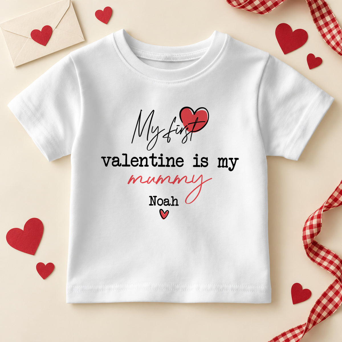 Personalised my first Valentine is my Mummy kids T-shirt: a white tee with script and typewriter lettering, a red heart and an example name