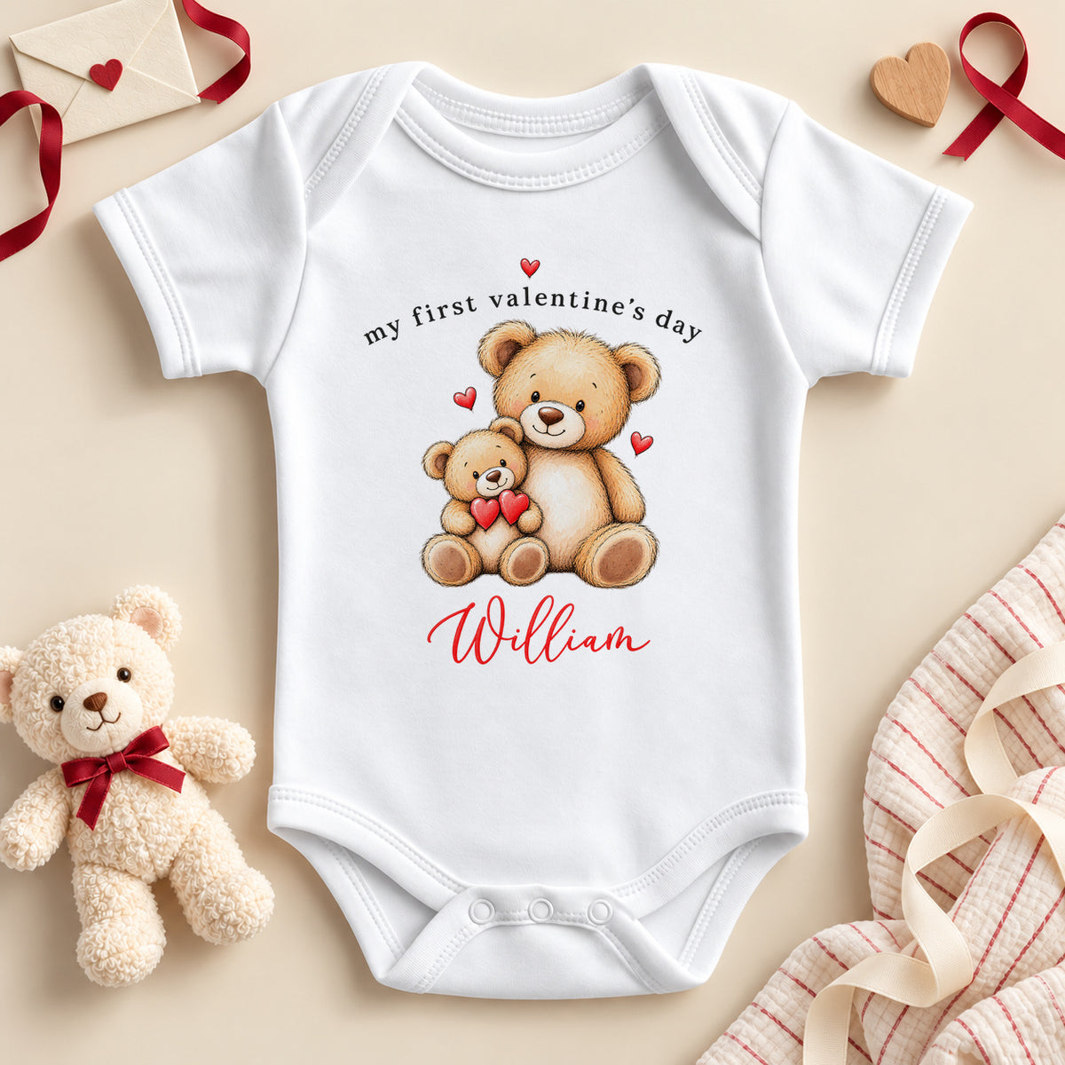 Personalised My First Valentine's Day baby bodysuit: a white baby vest with two cuddling teddy bears, red hearts and an example name in red script