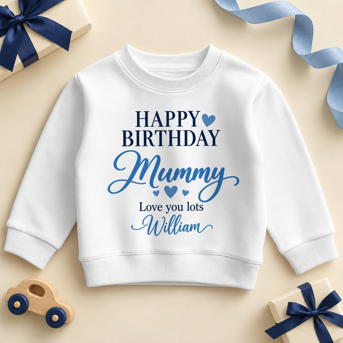 White kids sweatshirt printed Happy Birthday in navy capitals with a blue heart, Mummy in blue script, Love you lots and the example name William.