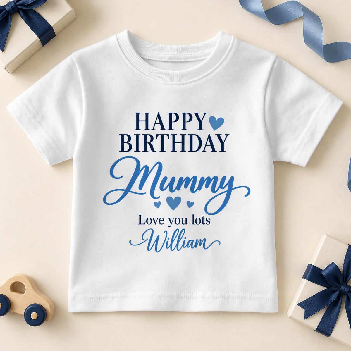 White kids T-shirt printed Happy Birthday in navy capitals with a blue heart, Mummy in blue script, Love you lots and the example name William.