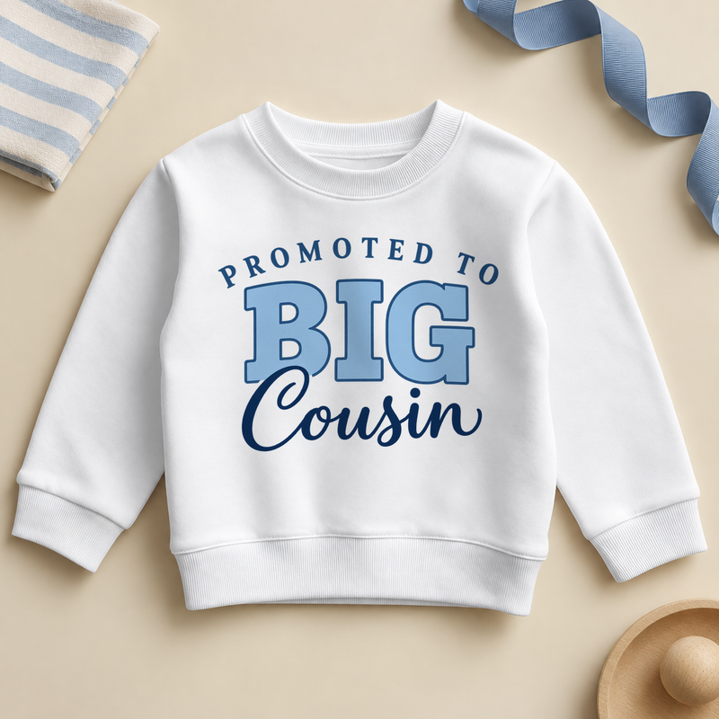 White promoted to big cousin kids sweatshirt with PROMOTED TO in arched navy letters, BIG in light blue outlined letters and Cousin in navy script