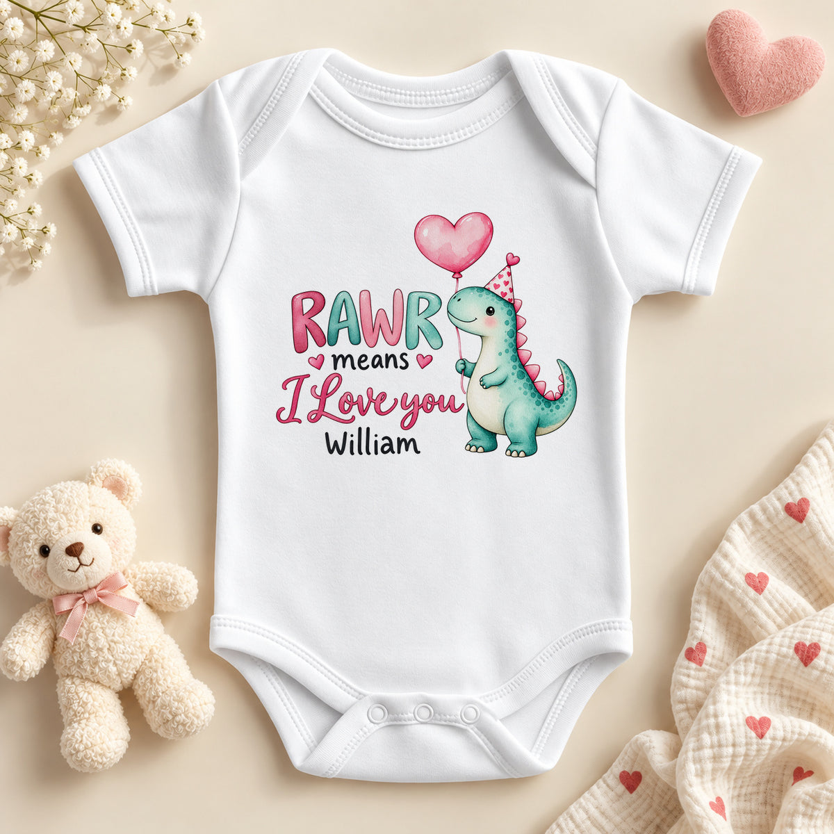 Personalised RAWR means I love you dinosaur baby bodysuit: a white baby vest with a teal dino holding a pink heart balloon, pink and teal letters and an example name