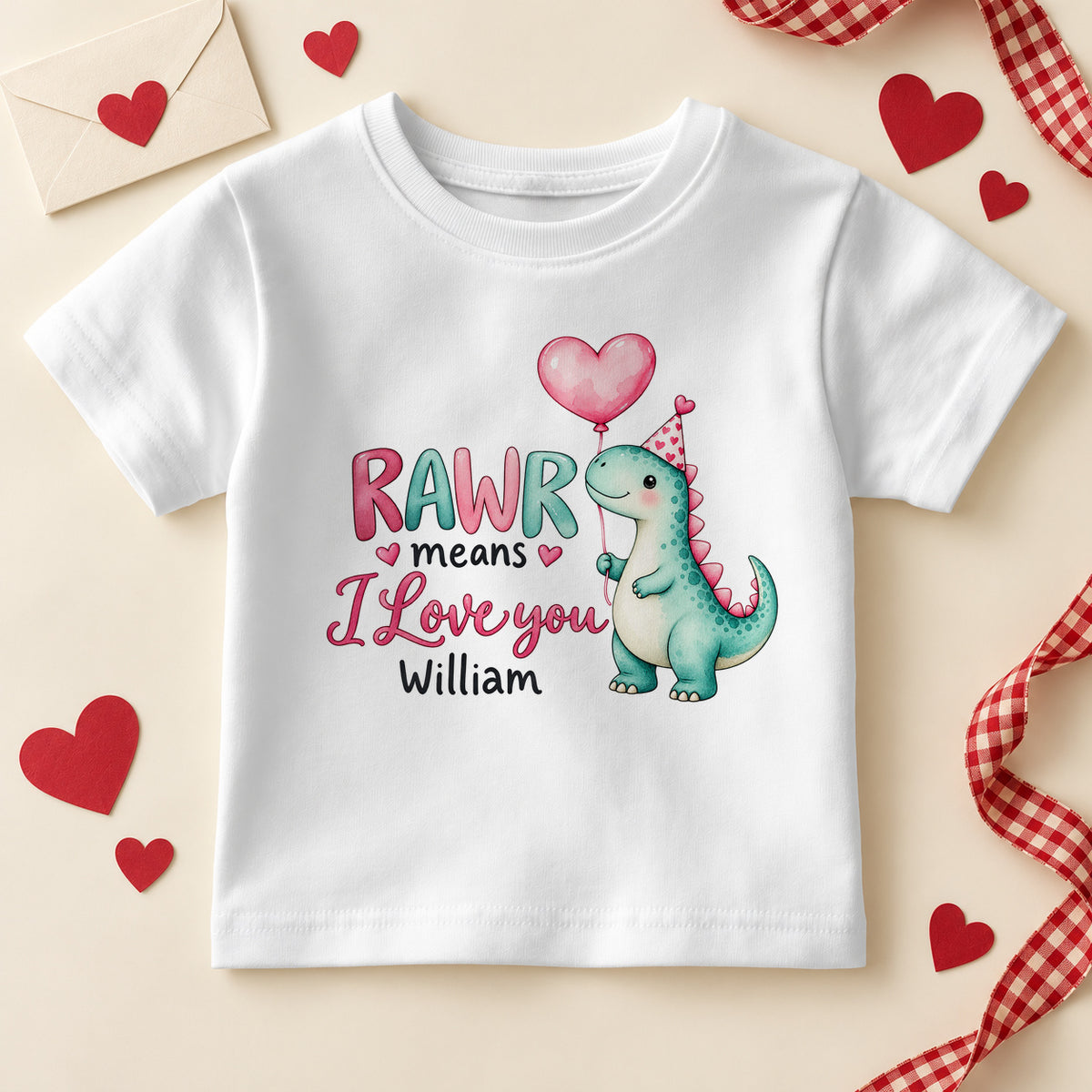 Personalised RAWR means I love you dinosaur kids T-shirt: a white tee with a teal dino holding a pink heart balloon, pink and teal letters and an example name