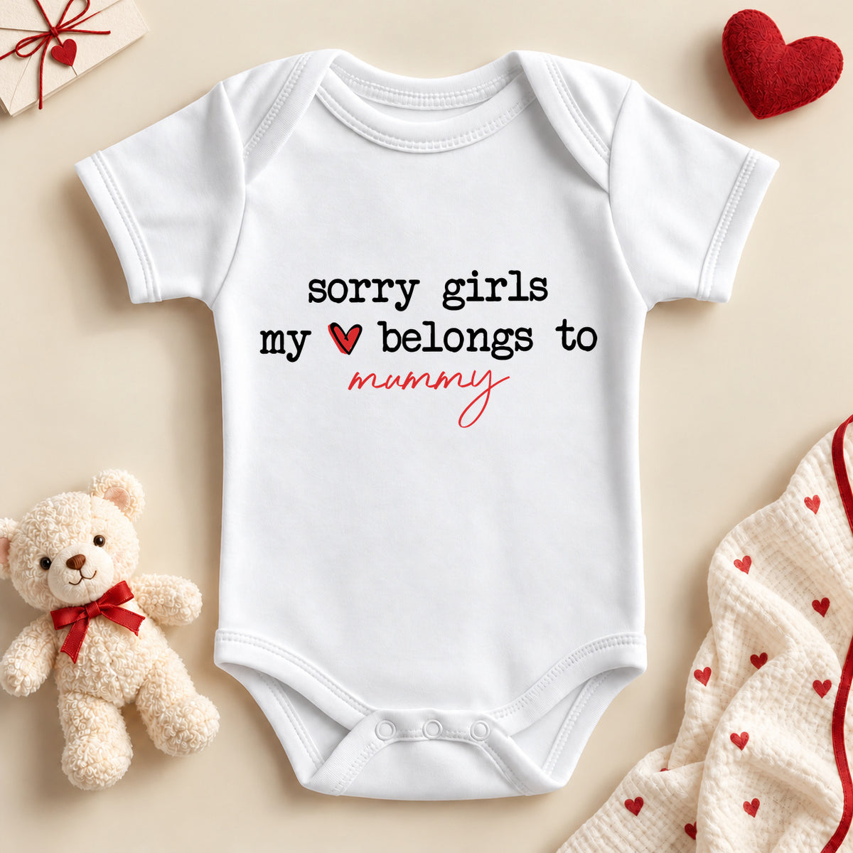 Sorry girls my heart belongs to mummy baby bodysuit: a white baby vest with black typewriter lettering, a red heart and mummy in red script